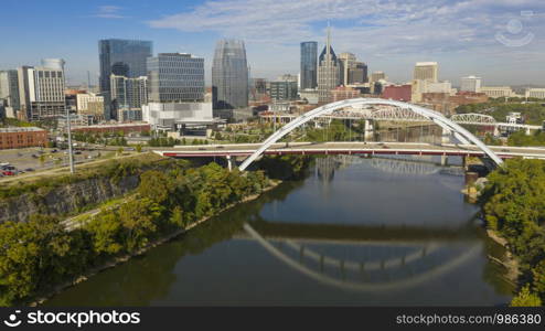 The Korean Veterans Memorial Bridge reflects in the calm Cumberland River early morning in Nashville TN