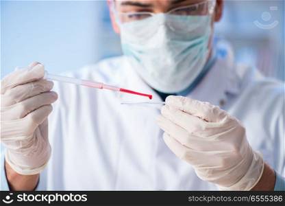 The lab assistant testing blood samples in hospital. Lab assistant testing blood samples in hospital