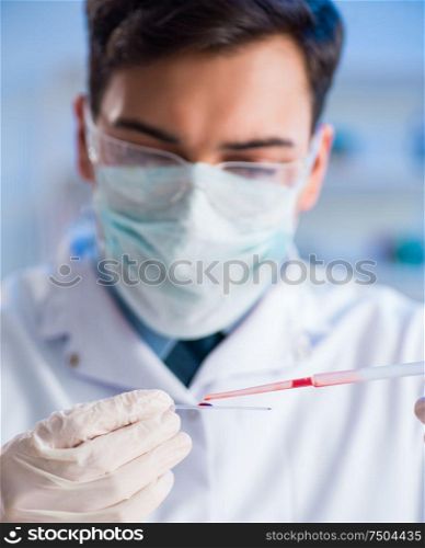 The lab assistant testing blood samples in hospital. Lab assistant testing blood samples in hospital