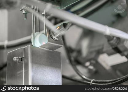 the laser reads the information from the plastic cover on the conveyor. bottle caps at the factory. equipment at the milk factory