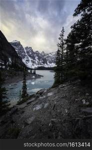 The last remaining ice breaks apart on Moraine Lake in early June at sunrise in the Canadian Rockies of Alberta, Canada.