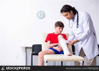 The leg injured boy visiting young doctor traumatologist . Leg injured boy visiting young doctor traumatologist 