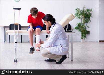 The leg injured boy visiting young doctor traumatologist . Leg injured boy visiting young doctor traumatologist