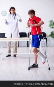 The leg injured boy visiting young doctor traumatologist . Leg injured boy visiting young doctor traumatologist