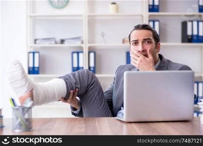 The leg injured male employee in the office. Leg injured male employee in the office
