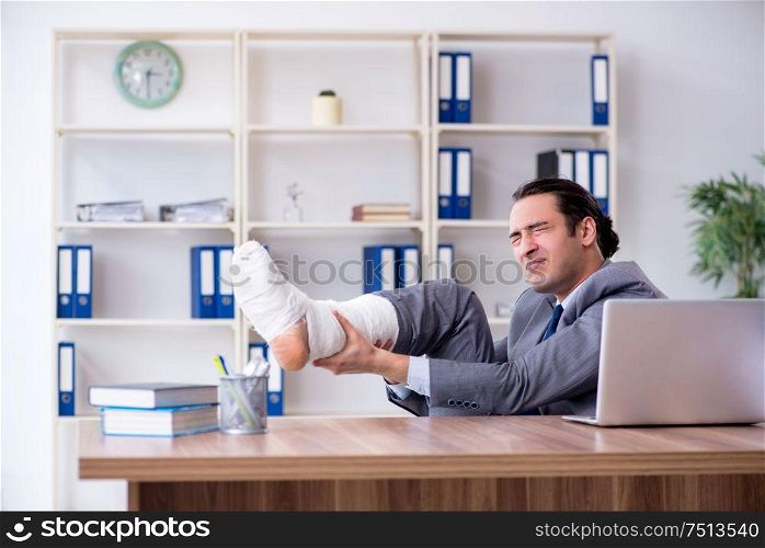 The leg injured male employee in the office. Leg injured male employee in the office