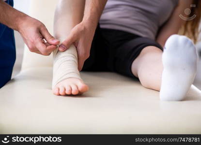 The leg injured woman visiting young doctor traumatologist. Leg injured woman visiting young doctor traumatologist