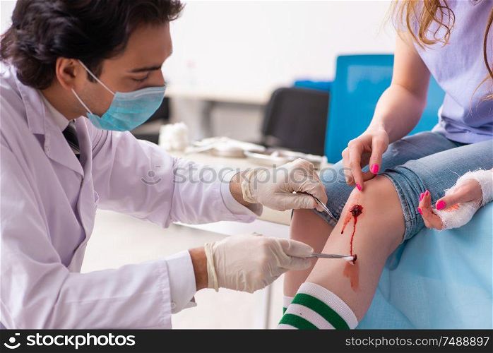 The leg injured young woman visiting male doctor. Leg injured young woman visiting male doctor