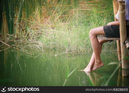 the legs of the relaxing young man.