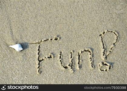 The letters and word fun written on the sand