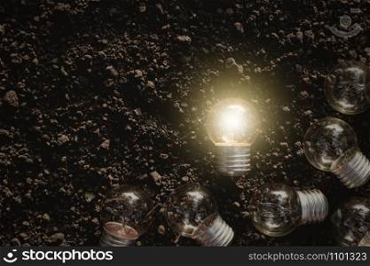 The light bulb is illuminating the ground, for use as background ideas.
