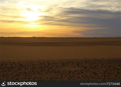 the light of the sunrise in the middle of the desert like adventure and wild concept