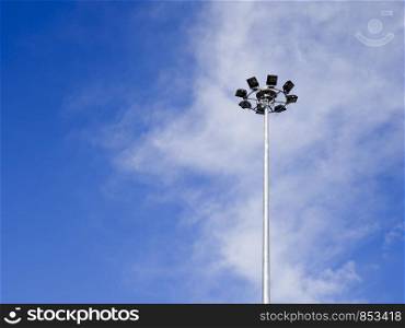 The light on the steel pole with blue sky and white cloud background.