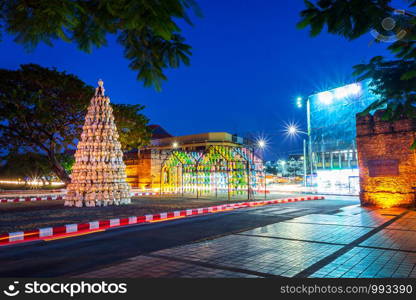 the light trails on the street at Chiang Mai Gate old city ancient wall and moat (chang phuak gate) of the evening in Chiang Mai,Thailand.