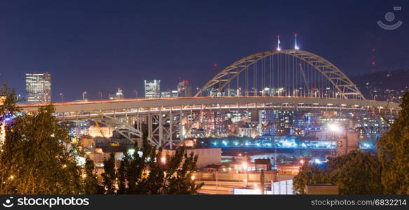 The lights sparkle at night in this panoramic view of the Freemont Bridge in Portland
