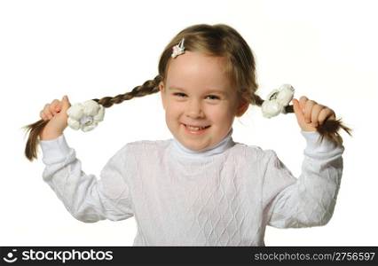 The little girl holds hands braids. It is isolated on a white background