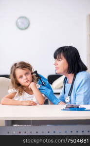 The little girl visiting old female doctor. Little girl visiting old female doctor