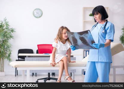 The little girl visiting old female doctor. Little girl visiting old female doctor