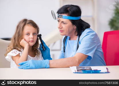 The little girl visiting old female doctor. Little girl visiting old female doctor