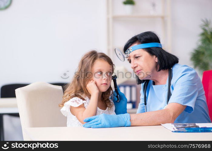 The little girl visiting old female doctor. Little girl visiting old female doctor