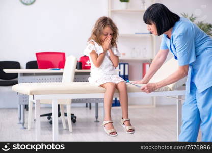 The little girl visiting old female doctor. Little girl visiting old female doctor