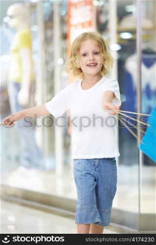 The little girl waving a bag in the store