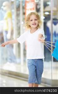 The little girl waving a bag in the store