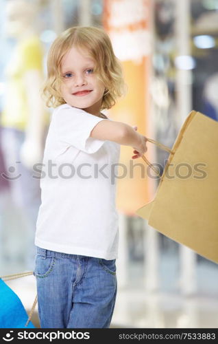 The little girl waving bags at the store