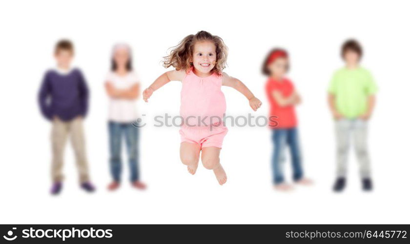 The little one of the family jumping and her brothers in the background