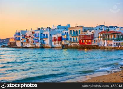 The Little Venice district with old colorful houses by the sea in Mykonos Island at sunset, Cyclades, Greece. Greek landscape