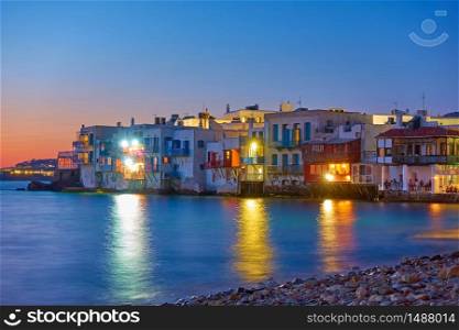The Little Venice district with old colorful houses by the sea in Mykonos island at twilight, Cyclades, Greece. Greek landscape