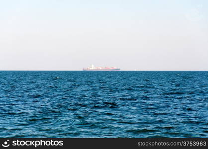 The Loaded Container Carrier far on horizon.