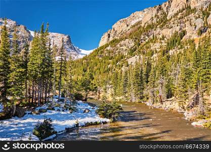 The Loch Lake, Rocky Mountains, Colorado, USA. . The Loch Lake with rocks and mountains in snow around at autumn. Rocky Mountain National Park in Colorado, USA.