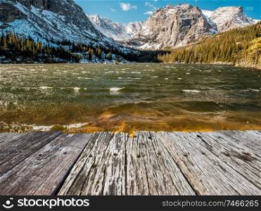 The Loch Lake with rocks and mountains in snow around at autumn. Rocky Mountain National Park in Colorado, USA. 