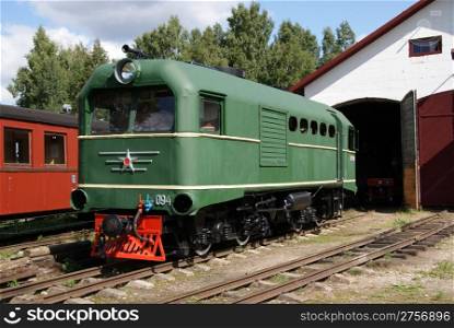 The locomotive of the narrow-gauge railway costs at depot