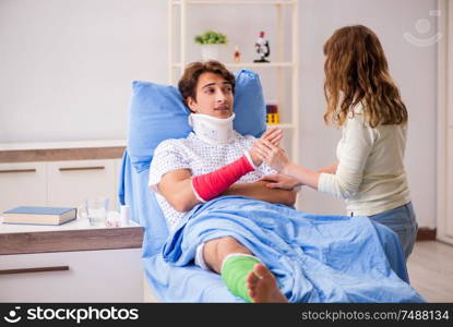 The loving wife looking after injured husband in hospital . Loving wife looking after injured husband in hospital