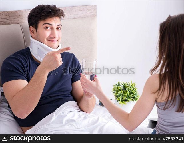 The loving wife taking care of injured husband in bed. Loving wife taking care of injured husband in bed