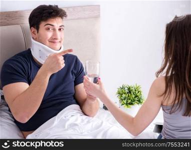 The loving wife taking care of injured husband in bed. Loving wife taking care of injured husband in bed