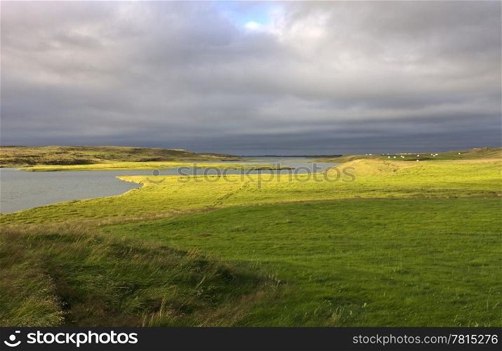 The low striking light hits the plains of the West Icelandic delta near Borganes on a pleasant evening with a gentil breeze