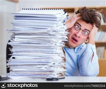 The mad businessman with piles of papers. Mad businessman with piles of papers