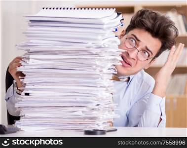 The mad businessman with piles of papers. Mad businessman with piles of papers