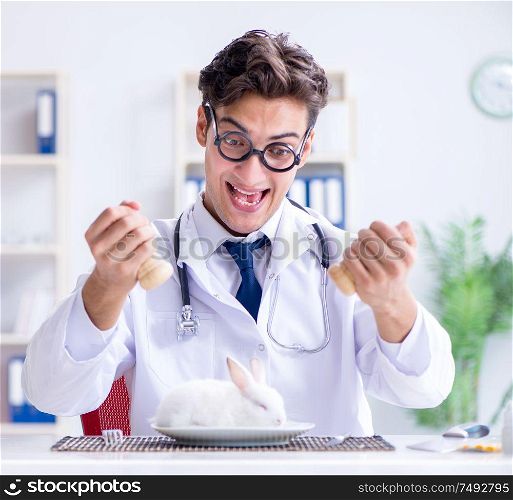 The mad crazy doctor preparing to eat rabbit. Mad crazy doctor preparing to eat rabbit