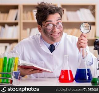 The mad crazy scientist doctor doing experiments in a laboratory. Mad crazy scientist doctor doing experiments in a laboratory