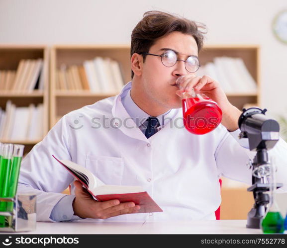 The mad crazy scientist doctor doing experiments in a laboratory. Mad crazy scientist doctor doing experiments in a laboratory