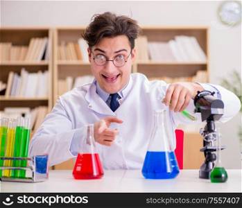 The mad crazy scientist doctor doing experiments in a laboratory. Mad crazy scientist doctor doing experiments in a laboratory