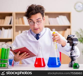 The mad crazy scientist doctor doing experiments in a laboratory. Mad crazy scientist doctor doing experiments in a laboratory