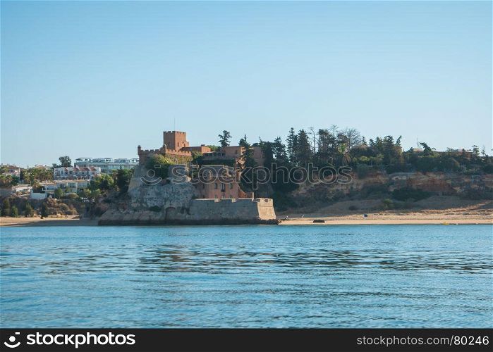 The magnificent Fort of Sao Joao do Arade in Ferragudo, sometimes referred to as the Castle of Arade, viewed from the Port of Portimao.