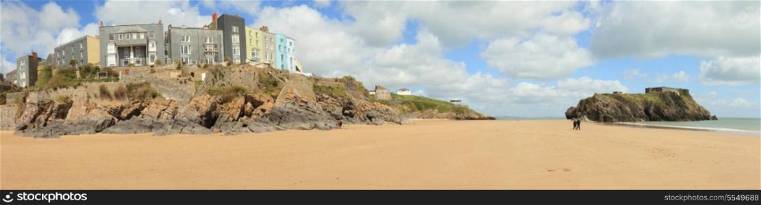 The main beach at Tenby, in West Wales, with its row of Victorian or Edwardian era hotels looking out from The Esplanade over the sands and the small island topped with an old fortification on the right.