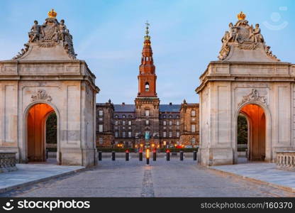 The main entrance to Christiansborg with the two Rococo pavilions on each side of the Marble Bridge during morning blue hour, Copenhagen, capital of Denmark. Christiansborg palace in Copenhagen, Denmark