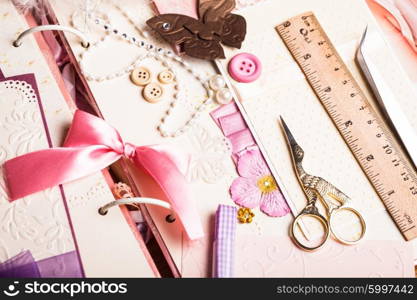 The making scrapbooking album with tolls and pink decorations. The making album
